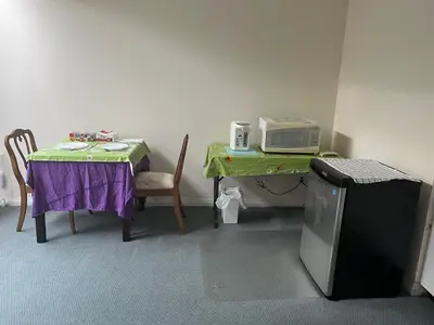 a room with a table with a microwave and a table with a table sidx sidx at Near Downtown YVR -2 Bedroom private suite in Vancouver