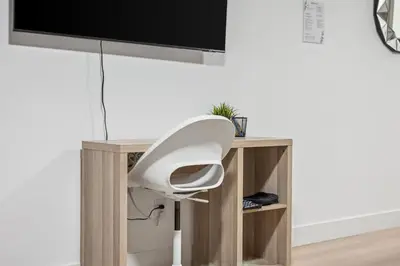 a white desk with a tv on top of it at NEST- Modern 2BR Basement Retreat in South Surrey in Surrey