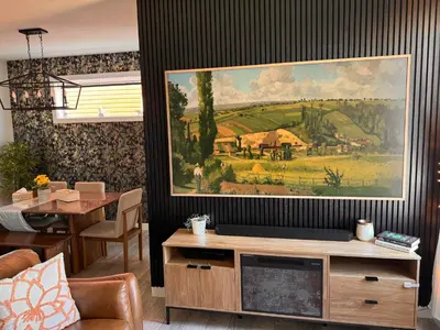 a living room with a painting on the wall at Z FamilyHome Suites & Apartments in Calgary