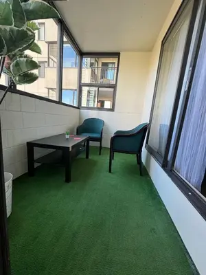 a room with two chairs and a table and a window at Entire Apartment Prime Downtown location Free underground Parking in Calgary