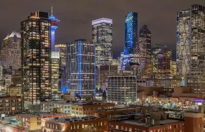 a city skyline with tall buildings at night at Entire Apartment Prime Downtown location Free underground Parking in Calgary