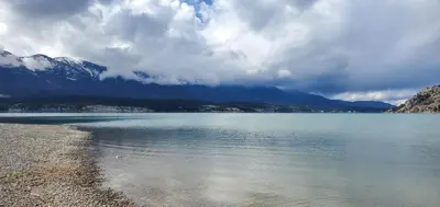 a large body of water with mountains in the background at Modern Condo Dream at Fairmont in Fairmont Hot Springs