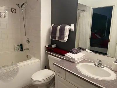 a bathroom with a sink and a toilet and a tub at Modern Condo Dream at Fairmont in Fairmont Hot Springs