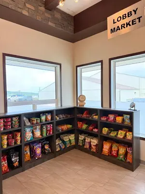 a grocery store with shelves filled with food at High Point Inn & Suites Peace River in Peace River