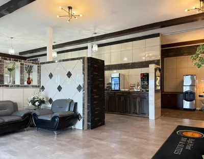 a lobby with two chairs and a barber shop at High Point Inn & Suites Peace River in Peace River