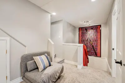a room with a chair and a painting on the wall at The Crest, Spacious, Central Condo, Free Parking in Whistler