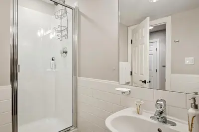a white bathroom with a sink and a shower at The Crest, Spacious, Central Condo, Free Parking in Whistler