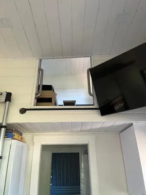 a living room with a tv and a window at Malaspina Strait Tiny Home in Powell River