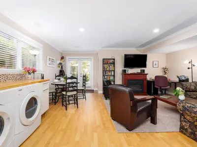 a living room with a kitchen and a dining room at Ferry Walk House in West Vancouver