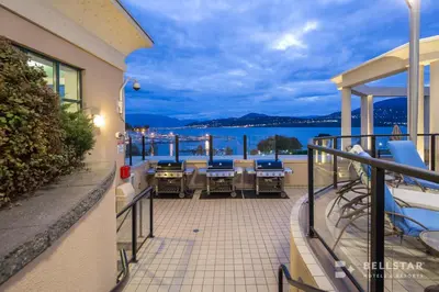 a balcony with chairs and a view of the water at The Royal Kelowna - Bellstar Hotels & Resorts in Kelowna
