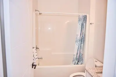a bathroom with a tub and a toilet and a shower at Brand-new three bedroom guest suite in the desirable neighbourhood in Prince George