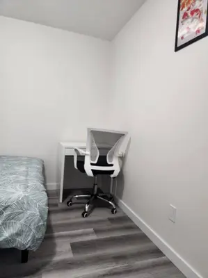 a bedroom with a desk and a bed at Modern 2 Bedroom Basement Suite Chappelle Edmonton in Edmonton