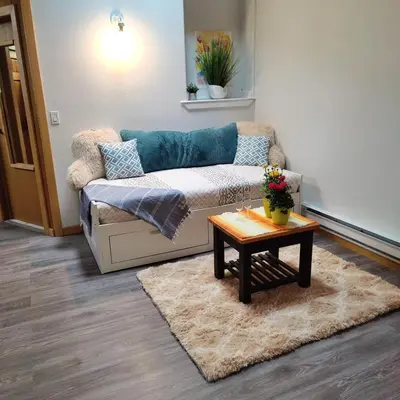 a living room with a couch and a coffee table at Hummingbird B&B in Gabriola