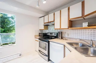 a kitchen with a sink and a stove at Entire home minutes from 3 lakes and a river! in Nanaimo
