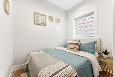 a bedroom with a bed and a window at Charming 3BR Home in a Lovely Vancouver Neighborhood in Vancouver