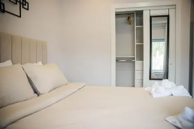 a white bed with towels on it in a room at Charming 3BR Home in a Lovely Vancouver Neighborhood in Vancouver