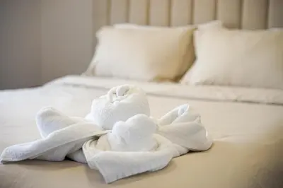 a towel sitting on top of a bed at Charming 3BR Home in a Lovely Vancouver Neighborhood in Vancouver