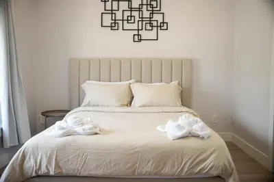 a bedroom with a white bed with white towels on it at Charming 3BR Home in a Lovely Vancouver Neighborhood in Vancouver