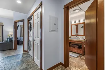 a laundry room with a washer and dryer at S105 Canmore Stay- Hot tub, stream rm, gym, parking Mtn Retreat in Canmore