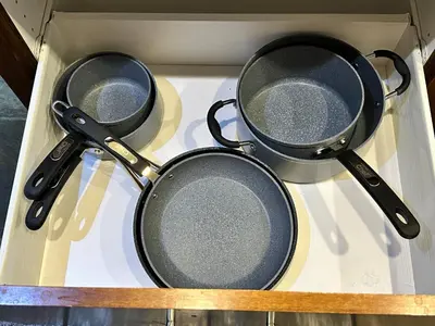 three pans sitting on top of a drawer at S105 Canmore Stay- Hot tub, stream rm, gym, parking Mtn Retreat in Canmore