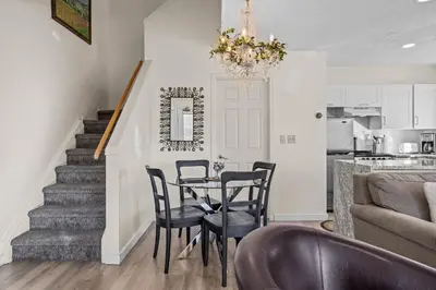 a kitchen and dining room with a table and chairs at B212 Hot Tub, AC x3, parking, 2 min to Banff Gate in Canmore