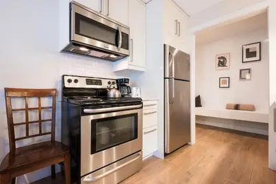 a kitchen with a stove and a microwave at Creekside Oasis 4 Beds Pool and Hot Tub in Whistler