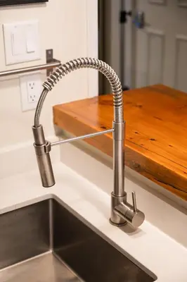 a kitchen sink with a chrome kitchen faucet at Creekside Oasis 4 Beds Pool and Hot Tub in Whistler