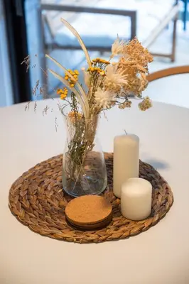 a tray with a vase and candles on a table at Creekside Oasis 4 Beds Pool and Hot Tub in Whistler