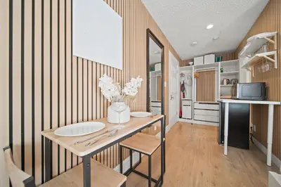 a kitchen with a table with flowers on it at Cozy Creek Den - Updated Nov 2025 in Whistler