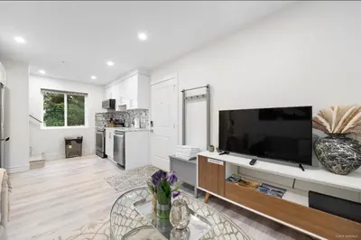 a living room with a large flat screen tv at Entire new small home in Vancouver