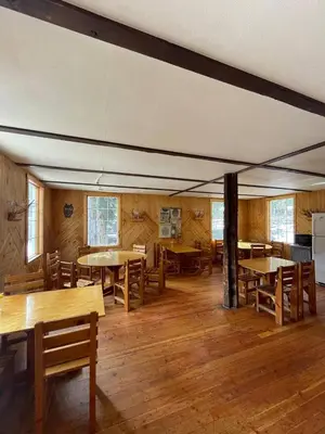 a dining room with wooden tables and chairs at Rustic Beaverfoot Lodge Room N3 in Parson