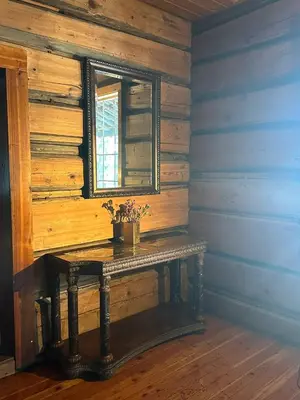 a wooden room with a table with a window at Rustic Beaverfoot Lodge Room N4 in Parson