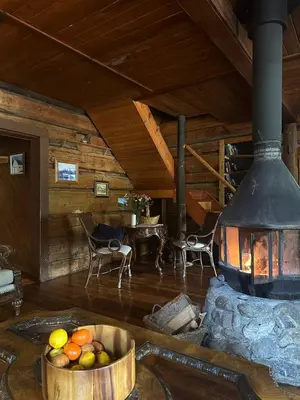 a living room with a large fireplace and a bowl of fruit at Rustic Beaverfoot Lodge Room N5 in Parson