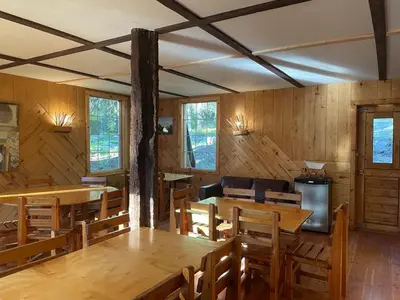 a dining room with wooden tables and chairs at Rustic Beaverfoot Lodge Room N6 in Parson