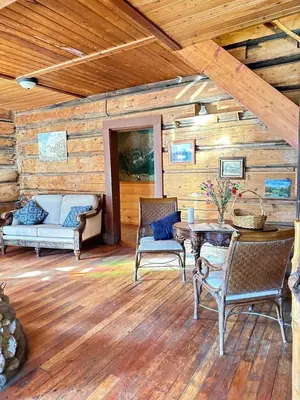 a living room with a table and chairs and a couch at Rustic Beaverfoot Lodge Room N8 in Parson