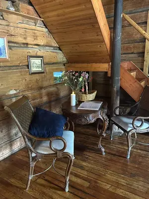 a room with a table and chairs in a cabin at Rustic Beaverfoot Lodge Room N8 in Parson