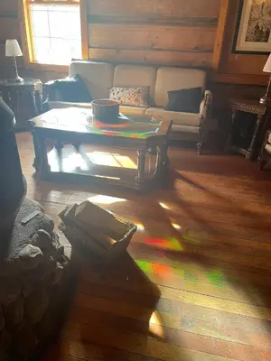 a living room with a coffee table and a couch at Rustic Beaverfoot Lodge Room N8 in Parson