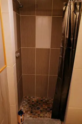 a bathroom with a shower with a shower curtain at Rustic Beaverfoot Lodge Room N10 in Parson