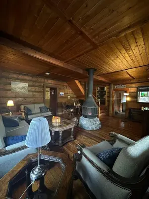 a living room with a fireplace in a log cabin at Rustic Beaverfoot Lodge Room N10 in Parson