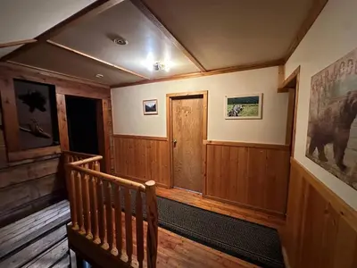 a room with a wooden staircase with a wooden door at Rustic Beaverfoot Lodge Room N10 in Parson