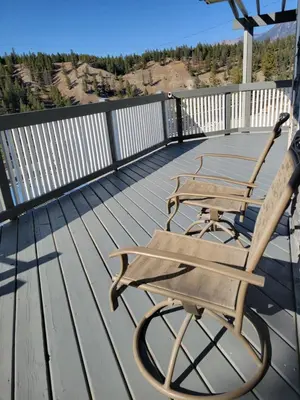 a wooden deck with a bench sitting on it at Cross Suite - MistyRiver Lodge in Radium Hot Springs
