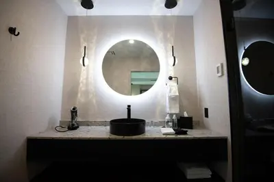 a bathroom with a sink and a mirror at the reid hotel in Vanderhoof