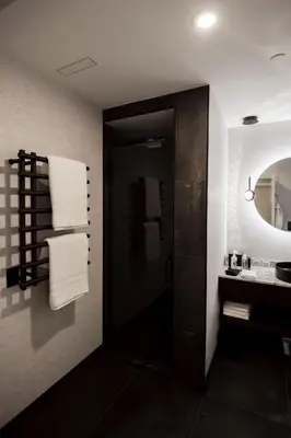 a bathroom with a sink and a mirror and towels at the reid hotel in Vanderhoof