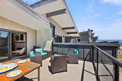 a patio with a table and chairs on a balcony at The Beach House at Saratoga #2 in Oyster Bay