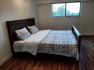a bedroom with a bed with two pillows on it at Farmestate in Vancouver