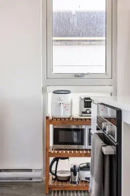 a kitchen with a microwave and a window at Cozy 1BR with AC, Chinatown, Rogers Arena, Seawall in Vancouver