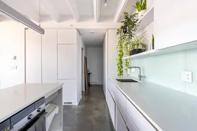 a kitchen with white cabinets and white appliances at Cozy 1BR with AC, Chinatown, Rogers Arena, Seawall in Vancouver
