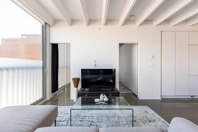 a living room with a glass table and a tv at Cozy 1BR with AC, Chinatown, Rogers Arena, Seawall in Vancouver