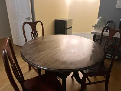 a wooden table and chairs in a room at Big band house in Burnaby
