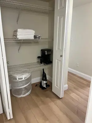 a room with a shelf with towels on it at 2 Beds Guest Suite to Yourself at Coquitlam Centre Mall in Port Coquitlam